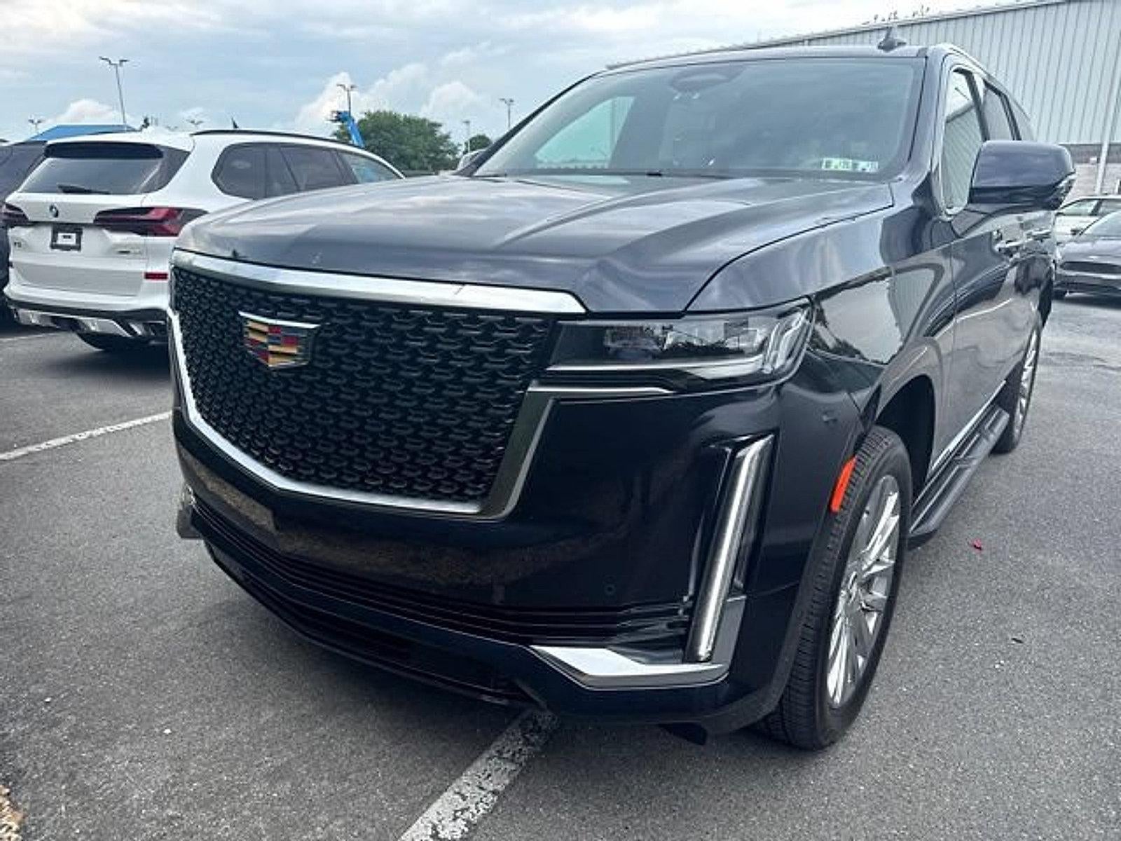 2023 Cadillac Escalade 4WD Premium Luxury in Dark Moon Blue Metallic — front three-quarter view