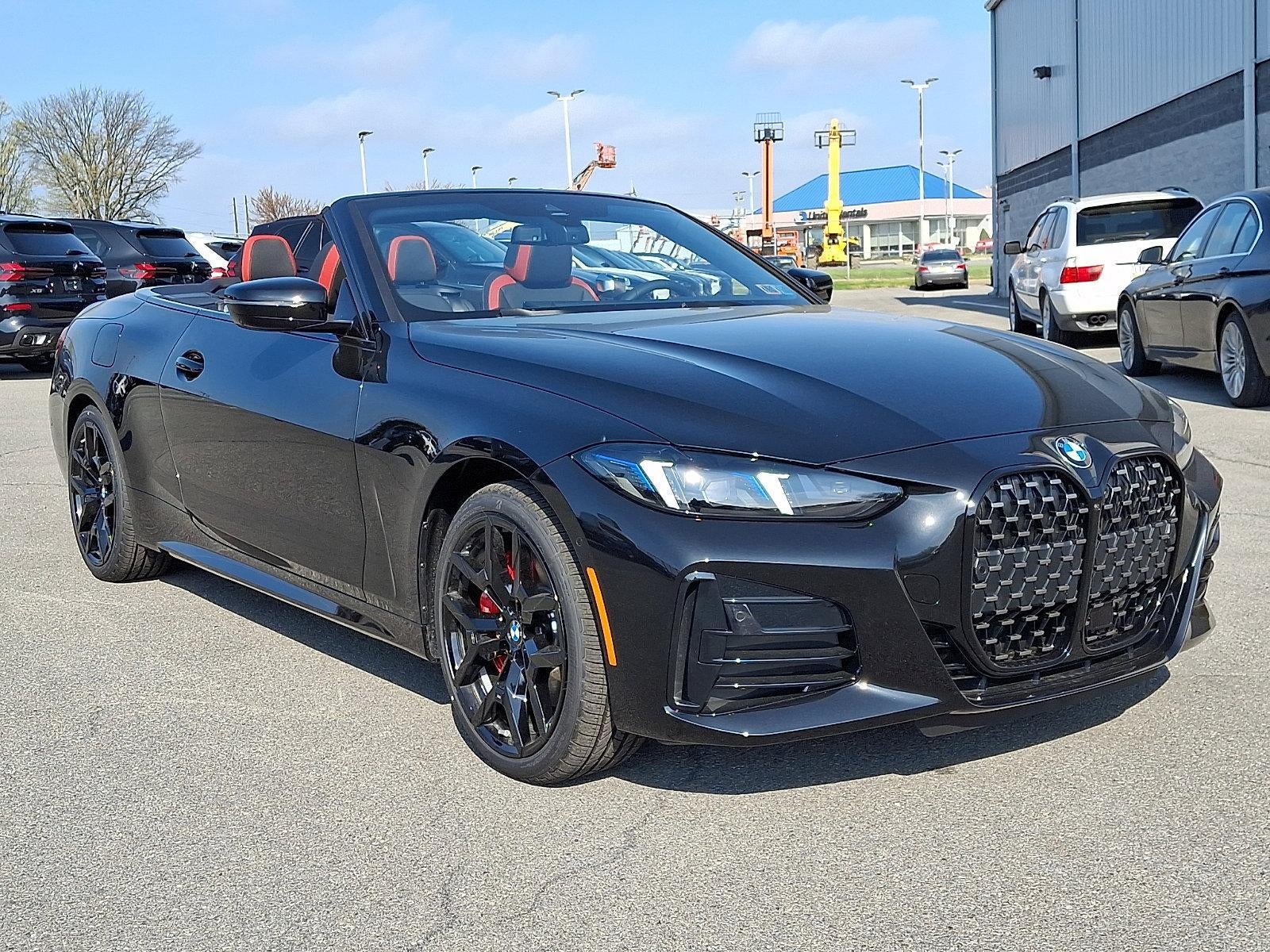 2026 BMW 430i xDrive Convertible in Black Sapphire Metallic — front three-quarter view